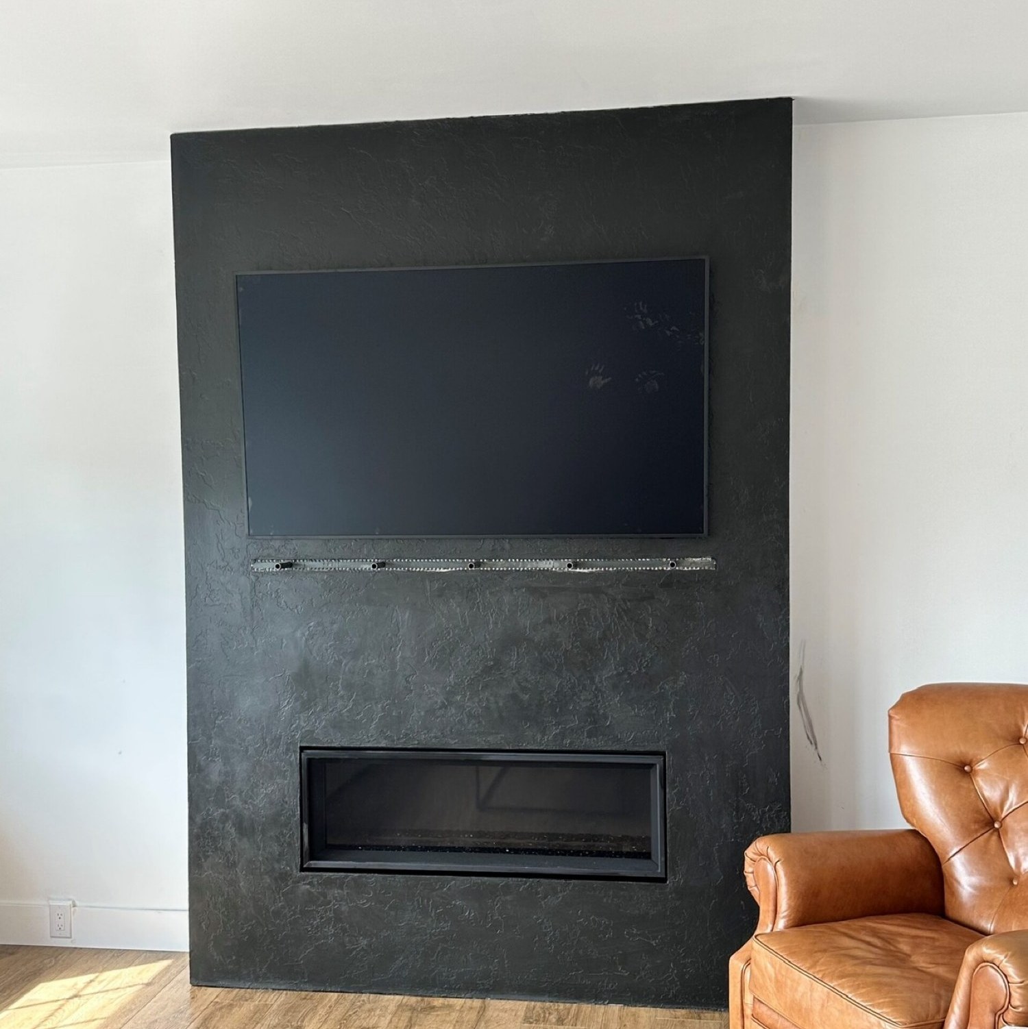Charcoal Italian lime plaster fireplace by Ronald Layman
